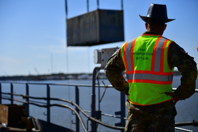 Chief Warrant Officer 2 Jordan Milo, a mobility warrant officer from the 841st Transportation Battalion, Charleston, South Carolina and the DEFENDER-Europe 21 Port of Portsmouth Operations Officer in Charge oversees Joint Logistics Over-The-Shore container lift operations at the Port of Portsmouth, Va. April 3, 2021.