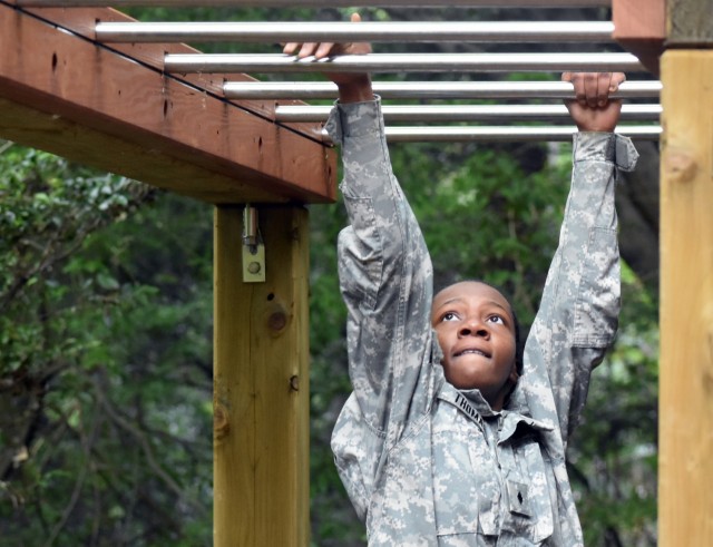 Cadet Maj. Queen Thomas completes the monkey bars portion of the obstacle course during the Zama Middle High School Junior Reserve Officers’ Training Corps Cadet Leadership Challenge at Camp Zama, Japan, April 6.