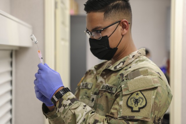 Spc. Exequiel Pascual with Joint Task Force 17 measures a dose of the Janssen vaccine at the mobile vaccination unit site, Thursday, April 8, 2021 in Pahrump, Nevada.