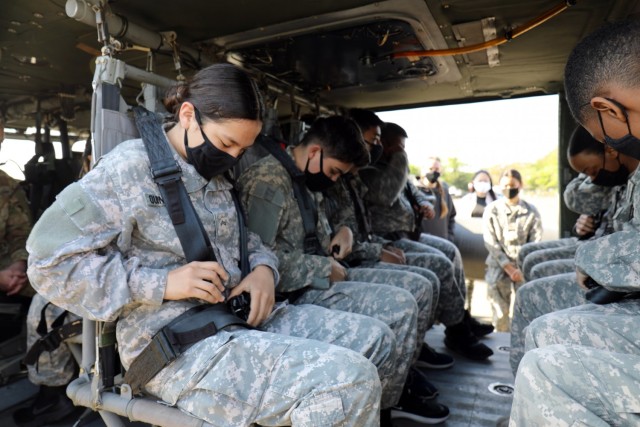 Cadet Cpl. Barbara Quinteros practices putting on her seat belt in a Black Hawk during the Zama Middle High School Junior Reserve Officers’ Training Corps Cadet Leadership Challenge at Kastner Army Airfield, April 8.
