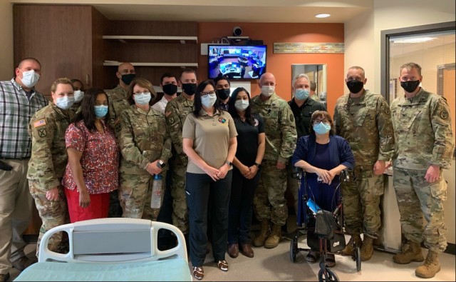Members of the CRDAMC tele-critical care launch team stand in front of one of twelve newly installed video monitors that will serve as a technology-driven patient care platform linking providers and their patients with board-certified...