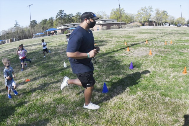 Yorktown Child Development Center youths follow Functional Fitness Instructor Jordan M. Fields through a course during an exercise session April 7 on one of the Child and Youth Services’ athletic fields. As part of a new program, Fields leads three classes a week for CDCs and School Age Services on a rotational basis but hopes to increase participation as facilities gradually expand their capacity. (U.S. Army Photo by T. Anthony Bell)