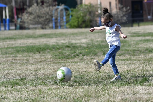 Izabelle Riley of the Yorktown Child Development Center kicks a ball during soccer drills April 7 during a functional fitness class. The instruction is intended to instill healthy exercise habits in young children.