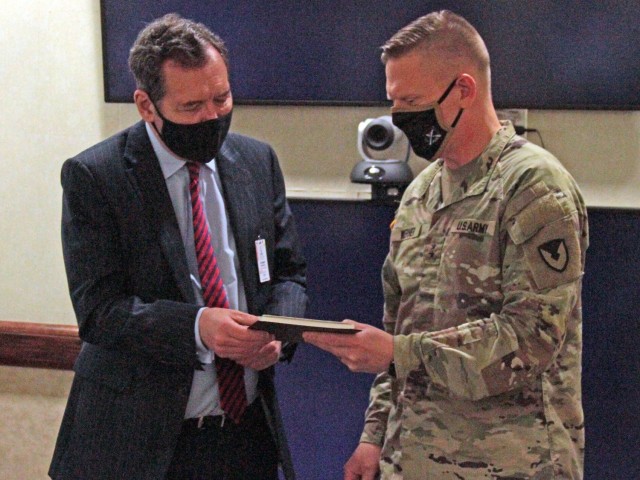 Maj. Gen. Darren Werner (right), Commanding General U.S. Army Tank-automotive and Armaments Command, presented Chris Bushell (left), Director General Land for the U.K. Ministry of Defence, with a pen set and a book “Images of America. Detroit’s Wartime Industry: Arsenal of America” by Michael W.R. Davis.