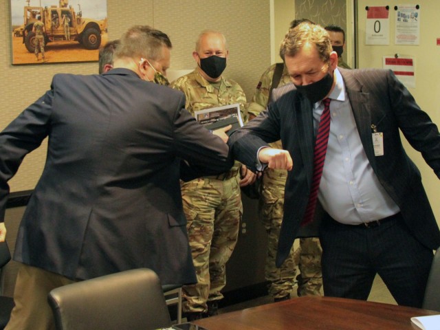 Michael Cadieux, Director Ground Vehicle Systems Center (left), greets Chris Bushell (right), Director General Land for U.K. Ministry of Defence, at the Detroit Arsenal, Michigan Apr. 13, in what has become the acceptable greeting during the COVID-19 pandemic .  The two met to give Bushell an overview of operations at GVSC.