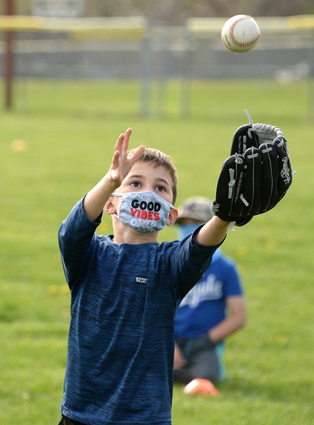 Six-year-old Daniel Wampler practices catching a pop fly at one of the skills stations during the Child and Youth Services Youth Sports and Fitness Spring Youth Baseball Skills Clinic April 12 at Doniphan Field. Participants rotated from the pop...