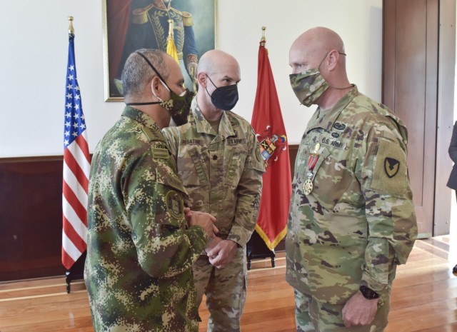 Gen. Eduardo Zapateiro, the Colombian National Army commanding general, presents the 'Faith in the Cause' medal to Brig. Gen. Douglas Lowrey, commander of U.S. Army Security Assistance Command, at the Canton Norte base in Bogota, Colombia, 8 April...
