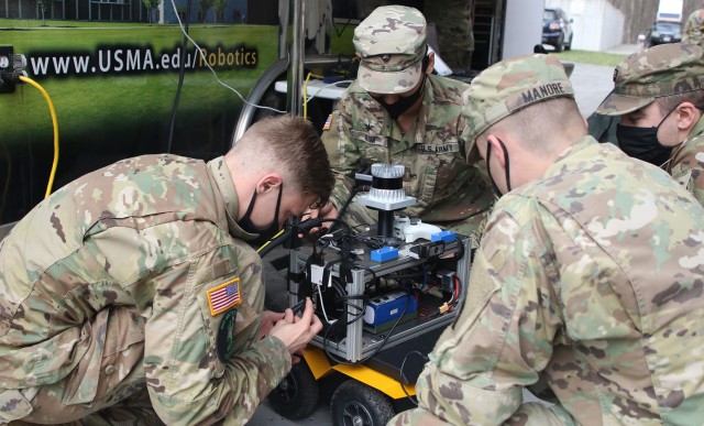 U.S. Military Academy cadets, as part of their capstone project working with unmanned systems, make last-second adjustments to an Unmanned Ground Vehicle (UGV/Jackal) during the Human-Robot Teaming — Competition (HuRT-C) on Saturday at West...