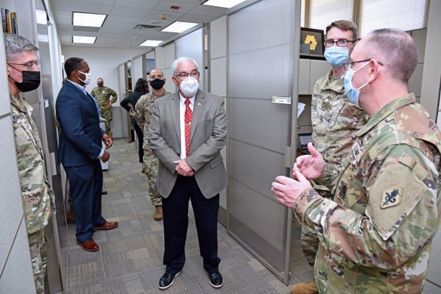 Col. James Jones, Interservice Physician Assistant Program Associate Professor (far right), briefs Mr. J.M. Harmon III, Deputy to the MEDCoE Commanding General, on the renovations and new furniture to their program area.
