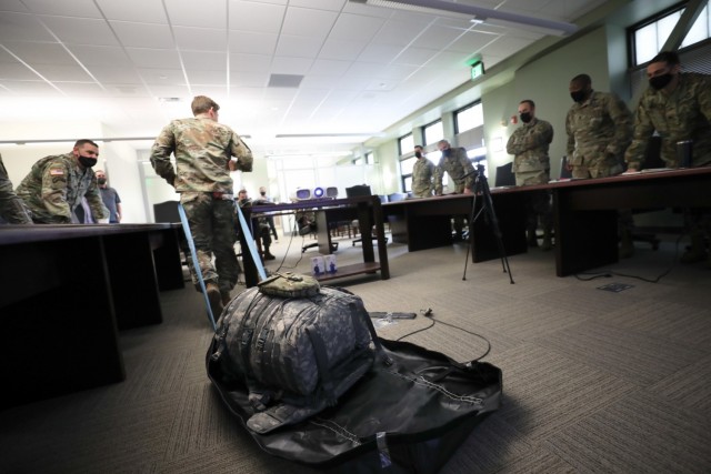 A paratrooper with 4th Infantry Brigade Combat Team (A), 25th Infantry Division, U.S. Army Alaska, demonstrates his idea of a foldable sled to leadership during a SPARwerx presentation event at Joint Base Elmendorf-Richardson, Alaska, April 14, 2021. SPARwerx is the digital technology innovation cell within the brigade allowing a medium for paratroopers to bring solutions to challenges faced in an Arctic environment. (U.S. Army photo by Staff Sgt. Alex Skripnichuk)