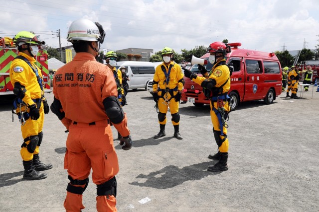 U.S. Army Garrison Japan Fire Department fire personnel, in yellow, participate in the Zama City annual disaster drill in Zama, Japan, Sept. 5, 2020.