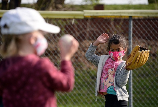 Five-year-old Ivana Bowman gets ready to catch a ball thrown by her partner, 5-year-old Erin Maher, during the Youth Sports and Fitness Spring Youth Baseball Skills Clinic April 12 at Doniphan Field. The skills clinic will be offered again May...