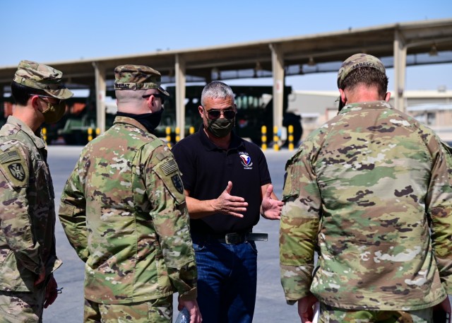U.S. Army civilian William Bravo, deputy to the commander, Army Field Support Battalion-Qatar (center), discusses steps being taken to deactivate and relocate equipment, with Michael F. LaBrecque, commander, 401st Army Field Support Brigade, and...