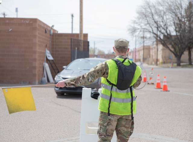 U.S. Army Spc. Jackson Greene, a cavalry scout assigned to 3rd Squadron, 61st Cavalry Regiment, greets community members as they enter the Pueblo Community Vaccination Site in Pueblo, Colorado, April 13, 2021. The Soldiers deployed from Fort Carson, Colorado to administer vaccinations to members of the Pueblo community to support the federal vaccination effort. U.S. Northern Command, through U.S. Army North, remains committed to providing continued, flexible Department of Defense support to the Federal Emergency Management Agency as part of the whole-of-government response to COVID-19. (U.S. Army photo by Spc. Jacob Moir)