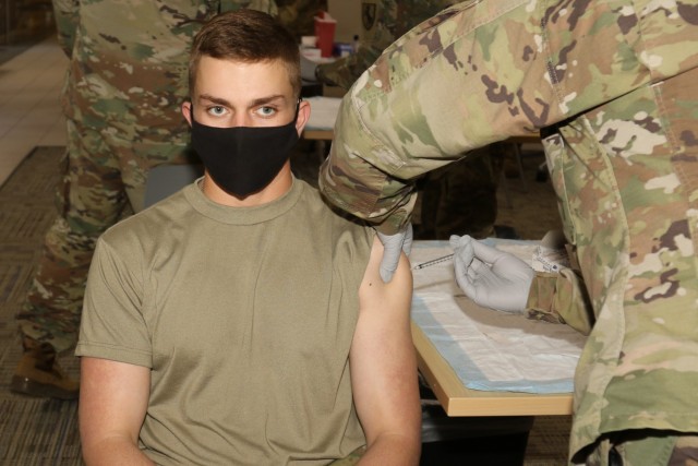 Pvt. Lucas McEachran, a chemical, biological, radiological, and nuclear specialist with Headquarters and Headquarters Troop, 2nd Squadron, 11th Armored Cavalry Regiment, is vaccinated with the Pfizer COVID-19 vaccine Apr. 13, 2021, at the Dr. Mary E. Walker Center on Fort Irwin, Calif., during Tier 2 vaccinations. McEachran, a Fresno, Calif. native, received the vaccine in the first group of individuals to be vaccinated since Fort Irwin transitioned to Tier 2 on April 7. (U.S. Army photo by Kimberly Hackbarth/ Weed ACH Public Affairs)