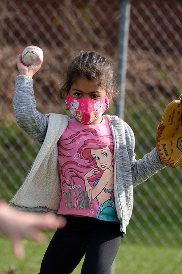 Five-year-old Ivana Bowman throws the ball back toward her partner during the Child and Youth Services Youth Sports and Fitness Spring Youth Baseball Skills Clinic April 12 at Doniphan Field. The skills clinic will be offered again May 3-13 on...