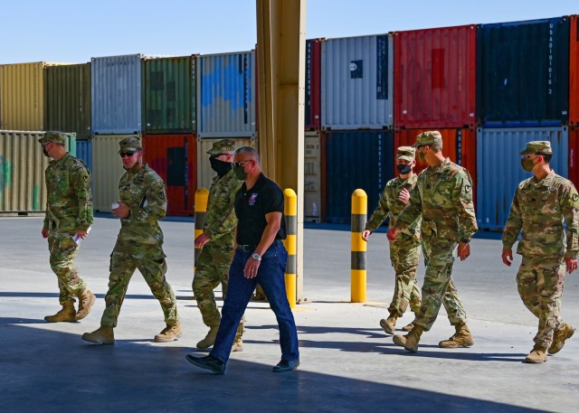 U.S. Army Col. Michael F. LaBrecque, commander, 401st Army Field Support Brigade, and Army Field Support Battalion-Qatar leadership, tour an empty pavilion previously used for maintenance and services, at Camp As Sayliyah, Qatar, Apr. 6. ...