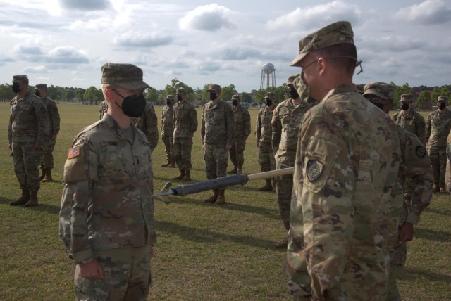 Col. John Popiak, commander of the Army Cyber Protection Brigade (right), and 1st Lt. Stephen Yonke (left) prepare to uncase the colors of the brigade's Raptor Detachment during an activation ceremony for the detachment at Fort Gordon, Ga., April 15, 2021. (Photo by Jeremy Garcia)