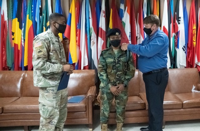 LT Agatha Kpamina, Ghana Armed Forces, is the first female from one of U.S. Africa Command’s partners – Ghana – to attend and complete the Infantry Basic Officer Course at Fort Benning, Georgia. Mark Irish, chief of the Maneuver Center of Excellence’s International Military Student Office presents the Infantry blue cord to Kpamina. 
Capt. Jordan Hill, C Company commander, 3rd Battalion, 81st Armor Battalion, 199th Infantry Brigade, presented the Foreign Military Badge that can be worn on her official uniform.