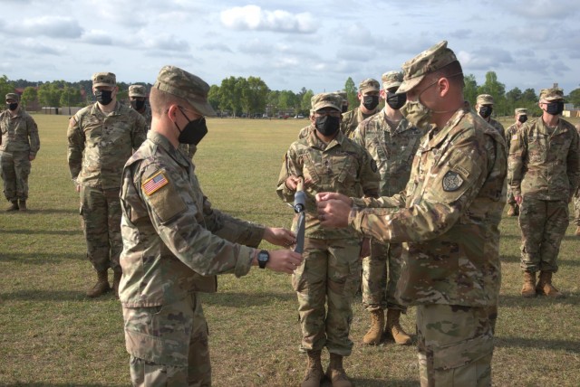 Col. John Popiak, commander of the Army Cyber Protection Brigade (right), and 1st Lt. Stephen Yonke (left) unfurl the colors of the brigade's Raptor Detachment during an activation ceremony for the detachment at Fort Gordon, Ga., April 15, 2021. (Photo by Jeremy Garcia)