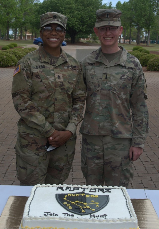 Sgt. 1st Class Britney Byrd (left), first sergeant for Raptor Detachment of the Army Cyber Protection Brigade, and 1st Lt. Stephen Yonke, detachment commander, pause for a photo during an activation ceremony for the brigade's Raptor Detachment at Fort Gordon, Ga., April 15, 2021. (Photo by Jeremy Garcia)