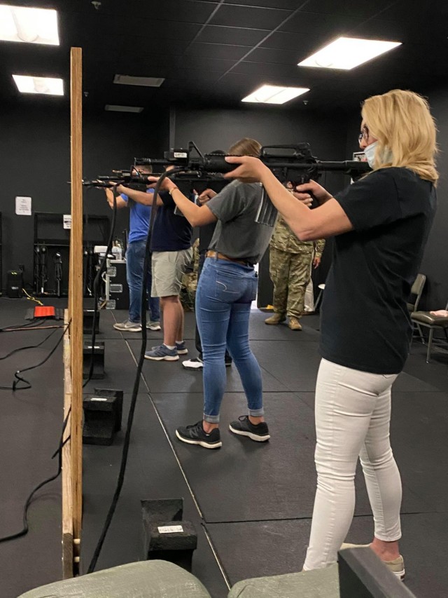Community leaders learn how to shoot M4 rifles in a simulated environment, April 8 at the Directorate of Plans, Training, Mobilization, and Security Engagement Skills Training facility on Fort Stewart, Georgia.
