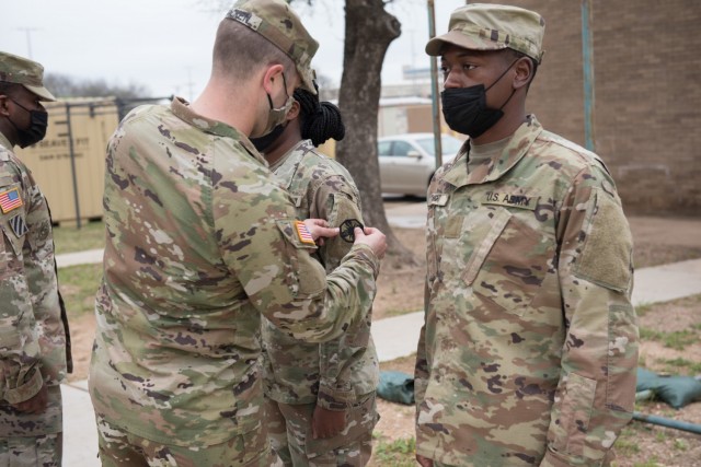 Tallahassee, Florida native and culinary specialist, Pfc. Jameilya Howard, 61st Quartermaster Battalion, receives her unit patch after completing the two-week Green Company cycle.  The Green Company is designed to create a lasting impact on all the Soldiers who come into the unit by showing them what right is, and not what it looks like. (U.S. Army photo by Sgt. 1st Class Kelvin Ringold)