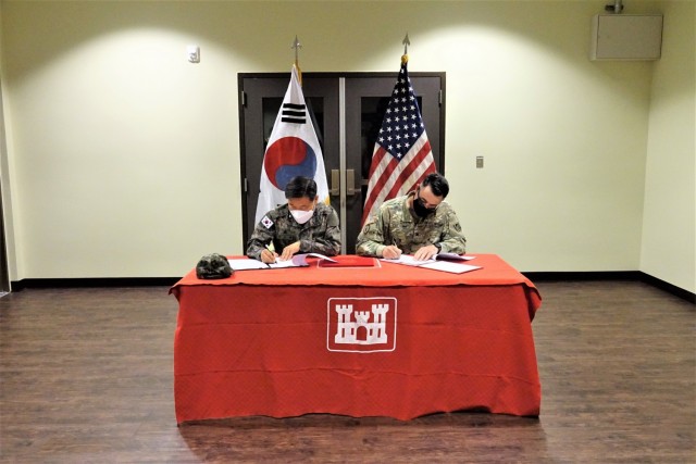 Col. Pyo In-tae (left), Chief, Program Management Team, Republic of Korea Design and Construction Agent, and Col. Garrett Cottrell (right), Deputy Commanding Officer - Transformation, U.S. Army Corps of Engineers Far East District, sign the...