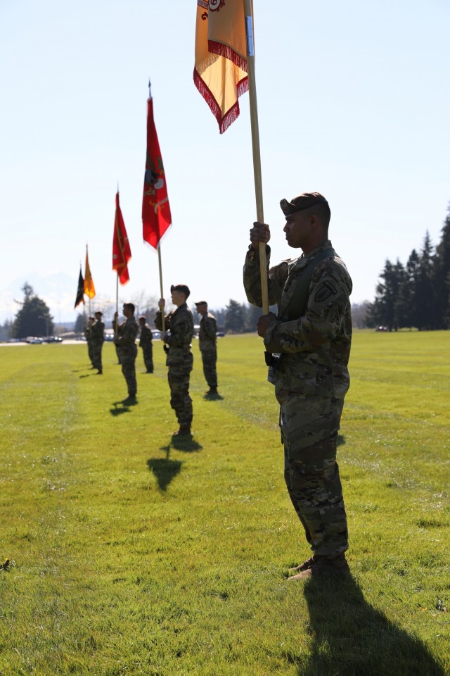 Advisors from 5th SFAB bear the colors of the six battalions along with the brigade colors at Watkins Field, Joint Base Lewis McChord, Washington, Apr. 16, 2021. During the ceremony, Brig. Gen. Curtis Taylor relinquished command to Col. Andrew Watson, Taylor takes command at the National Training Center at Fort Irwin, California next week.