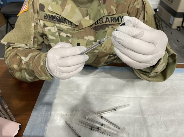 U.S. Army 1st Lt Kate Hammermaster, a medical surgical nurse assigned to the 626th Brigade Support Battalion, reconstitutes and draws vaccines at the Community Vaccination Center in Orlando, Florida, March 31, 2021. U.S. Northern Command, through U.S. Army North, remains committed to providing continued, flexible Department of Defense support to the Federal Emergency Management Agency as part of the whole-of-government response to COVID-19. (U.S. Air Force photo by MSgt Lakisha Croley/325th Fighter Wing, Public Affairs)