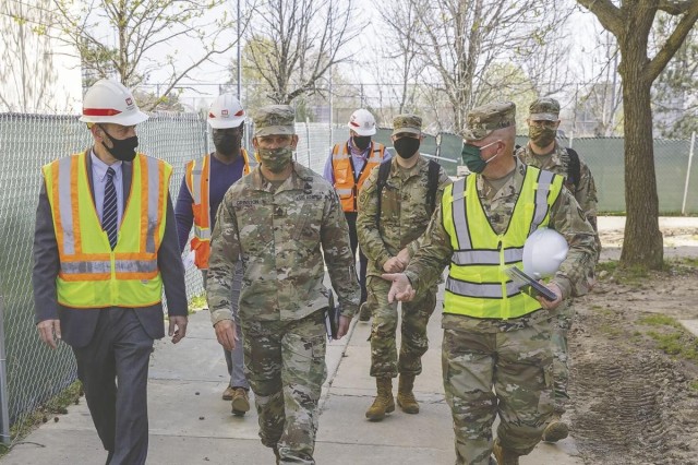 From left, Brian Smith, Garrison chief of housing; Sergeant Major of the Army Michael Grinston; and Garrison Command Sgt. Maj. Gregory Kleinholz, tour the renovations to enlisted barracks on Fort Belvoir, Tuesday.