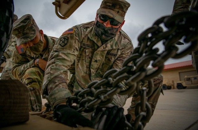 Soldiers from the 15th Transportation Company, 100th Brigade Support Battalion, 75th Field Artillery Brigade from Fort Sill, Okla., secure a vehicle to a transportation platform March 5, 2021, in preparation for a company convoy to Fort Hood, Texas, as they prepare for Warfighter 21-4, a multinational large-scale warfighter exercise. 