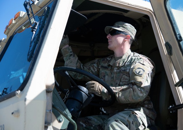 Cpl. Joseph DeSena, a motor transport operator with Headquarters and Headquarters Detachment, 91st Military Police Battalion, 10th Mountain Division (LI), sits in the driver's seat of a Light Medium Tactical Vehicle on April 19, 2021. DeSena's intervention in a possible domestic violence incident in his off-duty hours on March 7, 2021, greatly assisted the abilities of the local law enforcement and prevented possible injury. (U.S. Army Photo by Pfc. Anastasia Rakowsky)