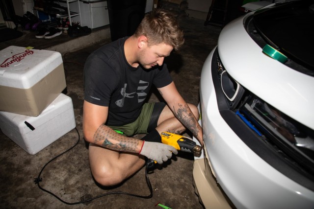 Spc. Billie Underwood applies heat to the vinyl wrap he is placing on the surface of a vehicle on April 16, 2021 in Ewa Beach, Hawaii. Underwood is human resources specialist assigned to the 94th Army Air and Missile Defense Command.