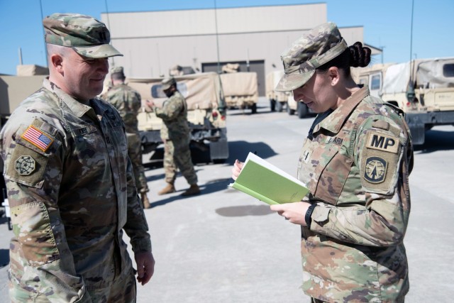 1st Lt. Melissa Campbell, a military police officer with Headquarters and Headquarters Detachment, 91st Military Police Battalion, 10th Mountain Division (LI) takes notes from Capt. Shaun Kiely, the commander of HHD, on April 19, 2021, at Fort Drum, N.Y. Campbell spotted a fellow Soldier intervening in a potential domestic violence incident on her way home on March 7, 2021, and stopped to provide additional assistance, preventing possible injuries and assisting the local law enforcement. (U.S. Army photo by Pfc. Anastasia Rakowsky)