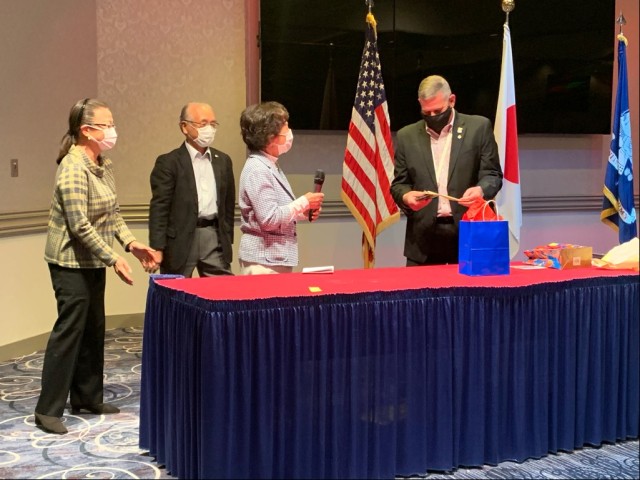 Members of the Japan-American Society Central Kanagawa present J. Steve Niederriter with a gift during his retirement ceremony April 16, 2021, at Camp Zama, Japan