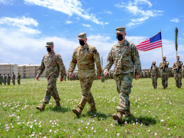 Task Force Phoenix Command Sgt. Maj. Refugio Rojas, Chief Warrant Officer 5 Rich Huber, and Col. Alan Gronewold perform their duties during a deployment ceremony after all mobilization training requirements were completed. During the ceremony the colors of each unit within the Task Force were cased and put in a protective sheath in preparation for the Brigade&#39;s movement overseas. 