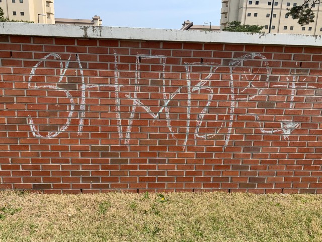 CAMP HUMPHREYS, Republic of Korea - A chalked message advocating for the Sexual Harassment/Assault Response and Prevention Program (SHARP) adorns the area next to a Humphreys barracks, April 21. Information, advocacy and activism regarding the...