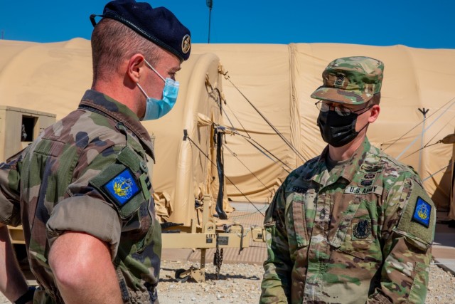 French Cpt. Arnaud Raedersdorf and U.S. Master Sgt. Brandon Bybee of the French Rapid Reaction Corps, French III Division take a break from the day’s briefings during Warfighter 21-4 March 29, 2021 at Fort Hood, Texas. U.S., United Kingdom and French Soldiers will work together over the course of two weeks to certify their respective corps and build multinational interoperability. (U.S. Army photo by Sgt. Evan Ruchotzke)