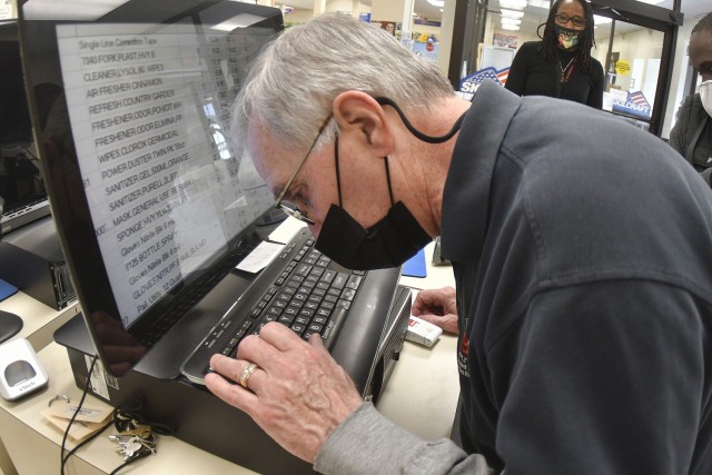 Sales associate Steve McGuire rings up items using magnified text April 14 at the Fort Lee AbilityOne Base Supply Center.  The federal AbilityOne Program supports disabled Americans with employment opportunities.