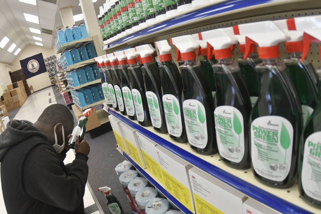 Sales associate Colling Knight reads the product label during a stocking job April 14 at the Fort Lee AbillityOne Base Supply Store. Knight, who is legally blind, began working at the retail facility that supports disabled employees since 2016.