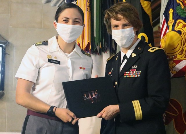 Cadet First Captain Reilly McGinnis (left), on behalf of the Corps, presented Brig. Gen. Cindy Jebb with a scrapbook filled with pictures of her time at West Point and messages submitted by current and former members of the Corps of Cadets.  