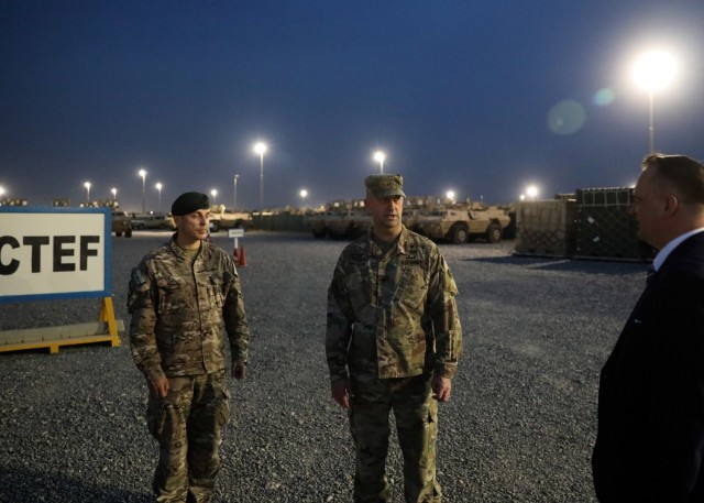 Army Reserve Brig. Gen. Justin M. Swanson (center), who deployed to Camp Arifjan, Kuwait, as the deputy commanding general of the 1st Theater Sustainment Command-Operational Command Post, leads a April 19, 2021 tour of the 1st TSC's Counter-ISIS, Training and Equipment Fund lot with Col. Adam Bascik, the military attaché at the Poland Embassy to Kuwait, and Polish Ambassador to Kuwait Pawel Lechowicz. The CTEF is a major effort to bolster Iraqi security forces in support of Operation Inherent Resolve. (U.S. Army photo by Staff Sgt. Neil W. McCabe)
