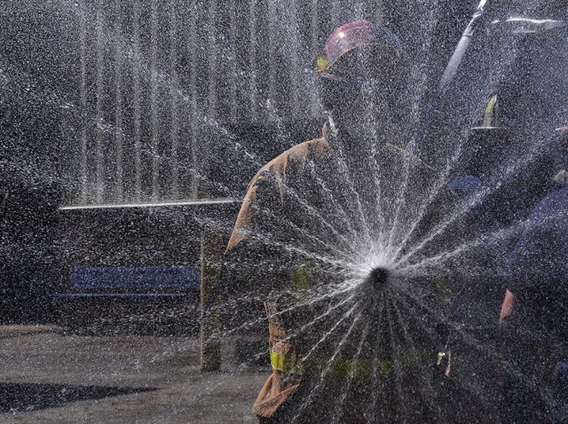 Pvt. Benjamin Szulgit demonstrates the improper way to extinguish fires by manipulating the nozzle control to the lowest setting during watercraft operator firefighting training April 16 at Joint Base Langley-Eustis.