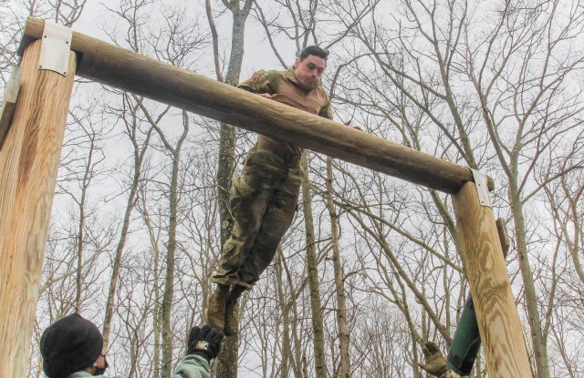 U.S. Military Academy Black Team leader Class of 2021 Cadet John Sweeney leaps to the higher log to get across the obstacle known as the ‘dirty name’ during the 52nd Sandhurst Military skills competition on April 17. Cadets mount the low log...