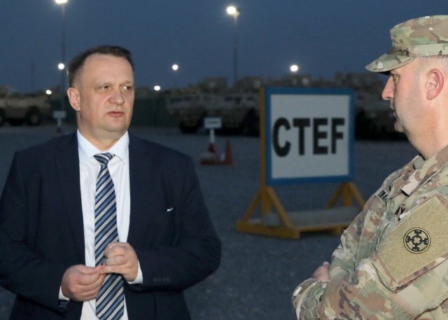 Polish Ambassador to Kuwait, Pawel Lechowicz speaks April 19, 2021, at Camp Arifjan, Kuwait,  with Army Reserve Brig. Gen. Justin M. Swanson, deputy commanding general of the 1st Theater Sustainment Command-Operational Command post, in the 1st TSC's yard for Armored Security Vehicles, Humvees and other vehicles intended for distribution to Iraqi security forces through the Counter-ISIS, Training and Equipment Fund, or CTEF, in support of Operation Inherent Resolve. Currently, Polish troops and civilian personnel deployed to OIR, including special operations soldiers and intelligence analysts, support partner nations. (U.S. Army photo by Staff Sgt. Neil W. McCabe)