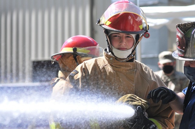 Pvt. Benjamin Szulgit -- an 88k Watercraft Operator Course student -- grips the hose tightly during the hose-handling exercise portion of firefighting training April 16 at the Transportation School’s fire trainer.