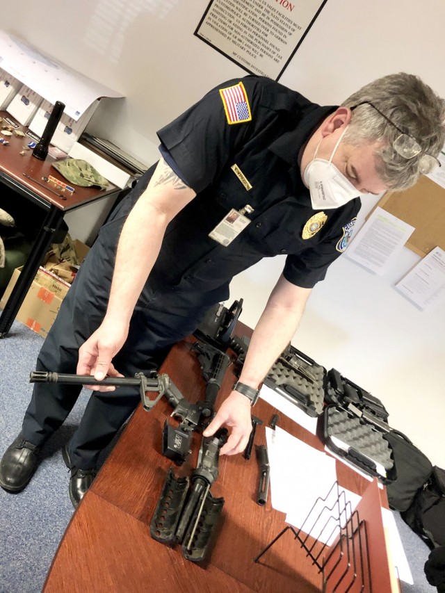 Customs Inspector Brian Harris, U.S. Army Europe-Africa Chief Customs Inspector in Rheinland-Pfalz, shows an AR-15 style rifle a Soldier shipped in their household goods. Customs inspectors had to destroy the rifle due to customs regulations.