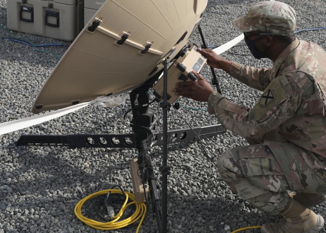 Alabama National Guard Spc. Anthony Hayes, 115th Expeditionary Signal Battalion, April 13, 2021 monitors the signal strength from the Tampa satellite dish that handled communications and data traffic during the Fort Knox, Kentucky, based 1st Theater Sustainment Command's expeditionary command post validation exercise at Camp Arifjan, Kuwait. Hayes, whose battalion is deployed to Camp Buerhing, Kuwait, said he appreciated getting real-world, unscripted training working in the ECP validation exercise. (U.S. Army photo by Staff Sgt. Neil W. McCabe)
