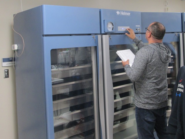 Felix Ortiz-Plaza, Fort Leonard Wood Blood Donor Center quality assurance officer, validates temperatures on a scientific refrigerator used to store blood in the newly constructed blood donor center.